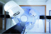 Figure 12 - IGRT machine. The CBCT detector is on the left, the source on the right, on either side of the bed. A MeV detector is at the bottom right, in line with the radiotherapy beam, for dosimetry purposes (ELEKTA's IGRT SYNERGY-3). This detector has very low detectivity (DQE(0) close to 1%), and the images it produces are very low-contrast, but usable (photo credit: ELEKTA AB).